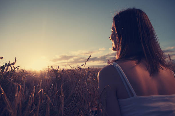 istock Girl watching beautiful sunset 486859720