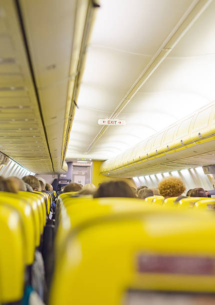 istock Interior inside of the plane with passengers. 486860543