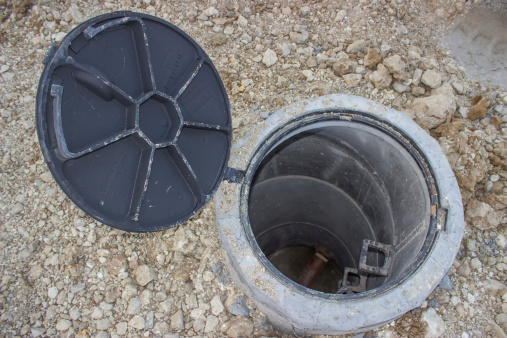Sanitary sewer under construction, view looking down into an open manhole