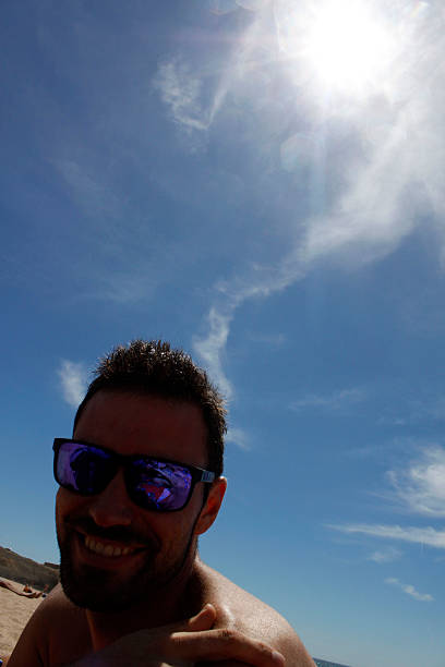 istock smiling guy on the beach in a sunny day 486862960