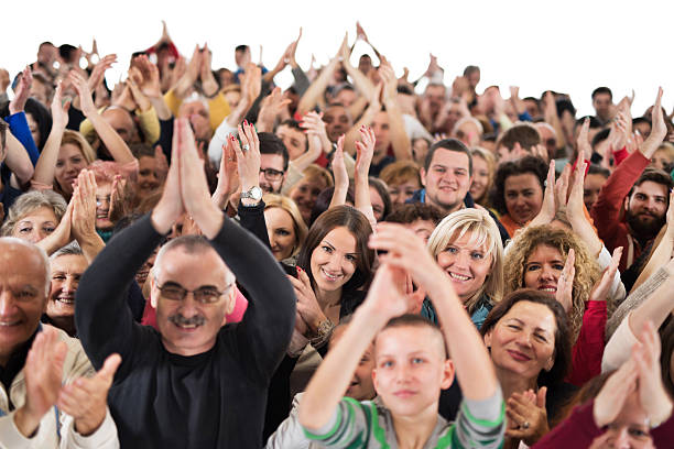 istock Large group of people applauding and looking at camera. 486865328