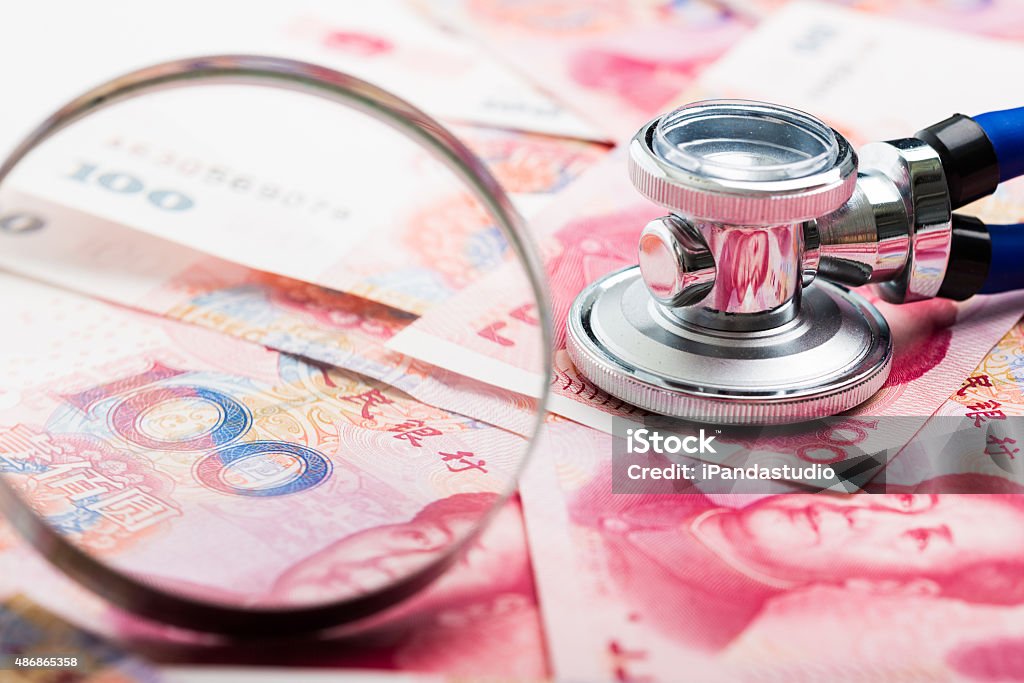 China Money Close up view of China money and stethoscope. China - East Asia Stock Photo