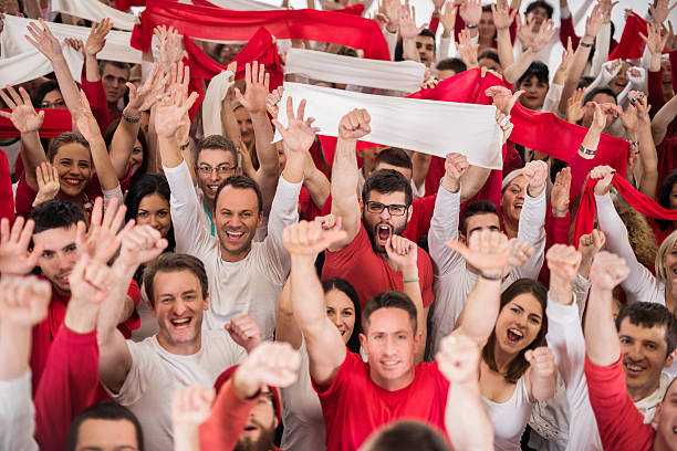 istock Group of ecstatic sport fans cheering and looking at camera. 486865652