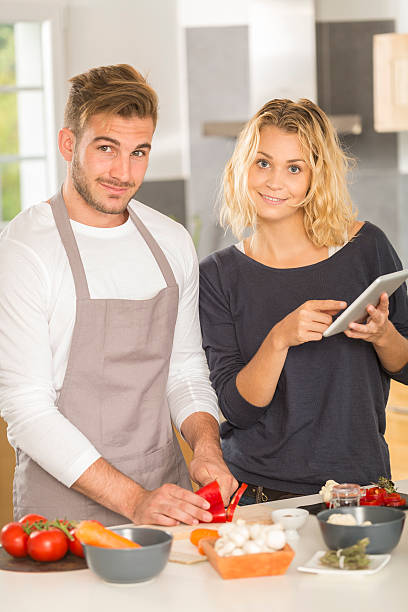 istock Young couple in kitche cooking dinner together 486866054