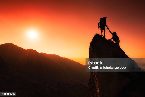 Team Of Climbers Help To Conquer The Summit Stock Photo - Download Image Now - Assistance, Support, Mountain