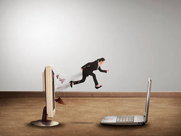 istock Business woman jumping from desktop computer to laptop 486866762