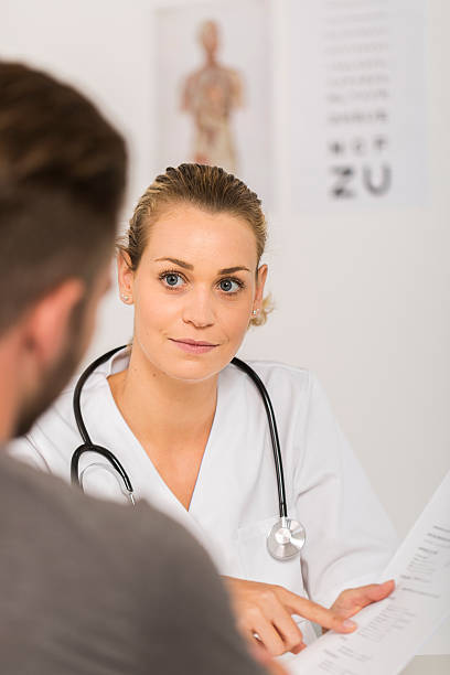 istock young doctor with patient 486866796