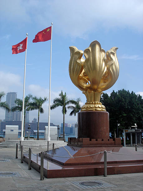 Hong Kong, Hong Kong S.A.R.-May 18, 2009: Hong Kong Golden Bauhinia Square with flags, blue sky and white clouds.