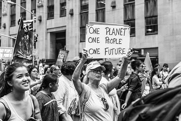Monochrome image of woman carrying a placard at PCM, NY stock photo