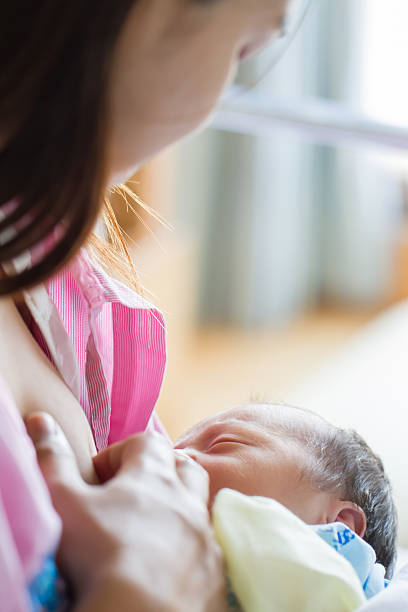 istock Mother feed her son with breast milk after delivery 486872270