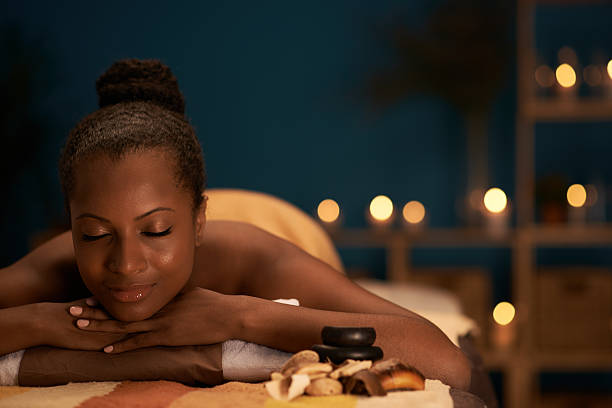Day in spa salon Lovely African-American woman spending her day in spa salon spas and spa treatments stock pictures, royalty-free photos & images