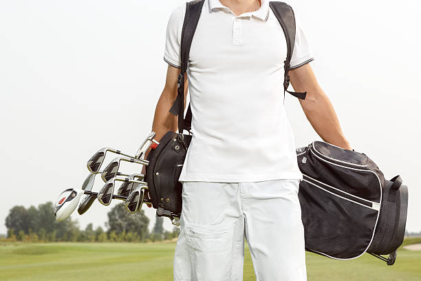 istock Man carrying his golf bag across course 486873440