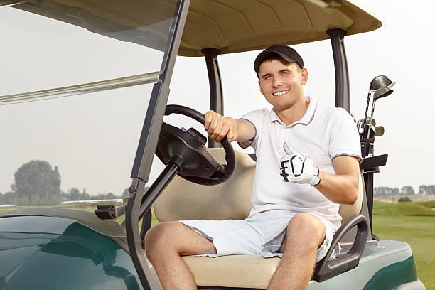 istock Young man driving cart on a golf course 486873526