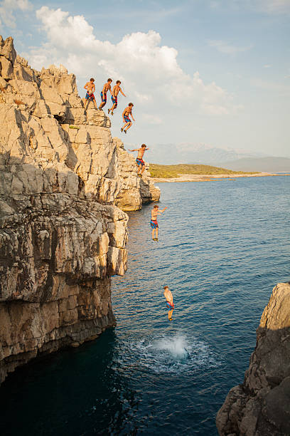 istock Sequence image of man on cliff diving into the sea 486874064