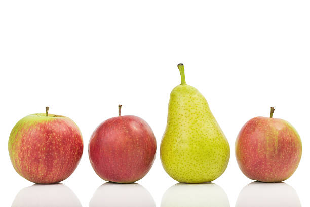 istock One pear in the middle of apples isolated on white 486874116
