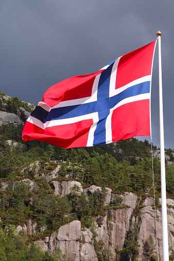 Flag of Norway - national symbol with nature in the background.