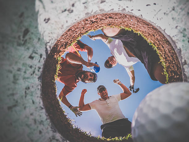 istock Point Of View Golf Players and Ball From Inside Hole 486876060