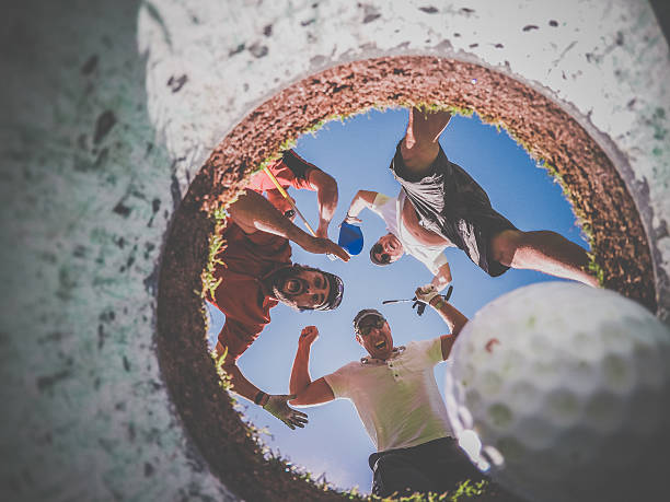 istock Point Of View Golf Players and Ball From Inside Hole 486876070