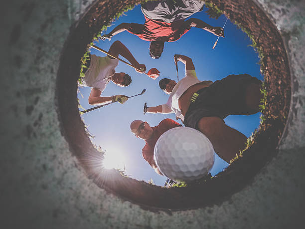 istock Point Of View Golf Players and Ball From Inside Hole 486876096