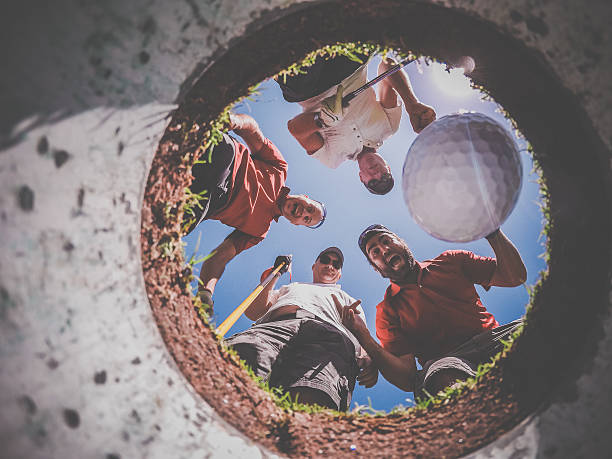 istock Point Of View Golf Players and Ball From Inside Hole 486876138