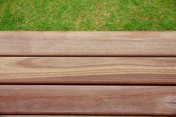 istock Stock Photo: Wood plank on natural green grass 486877010