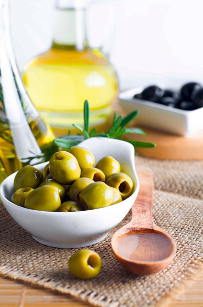 istock Olive oil and olive branch on the table 486877028