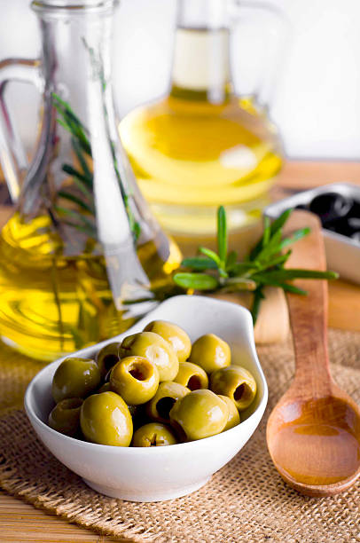 istock Olive oil and olive branch on the table 486877086