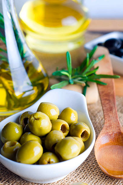 istock Olive oil and olive branch on the table 486877104