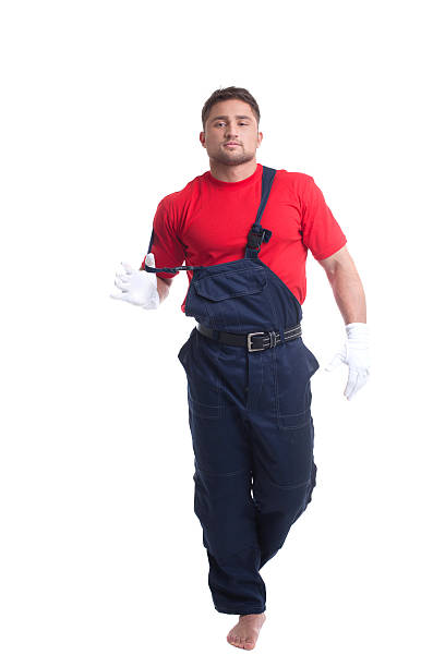 istock Handsome young man taking off his overalls 486878379