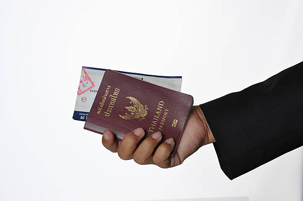istock Hand holding Thailand passport and boarding pass 486878398