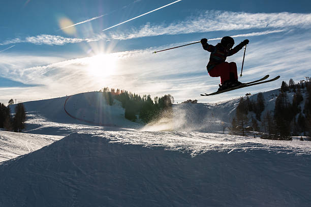 istock Little skier performs jump in the snow, silhouette 486879942