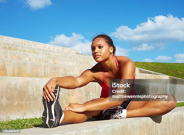 Healthy Young Pretty Mixed Race Woman Stretching Her Leg Stock Photo - Download Image Now