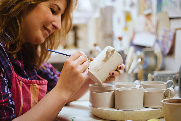 istock Pottery artist painting 486881409