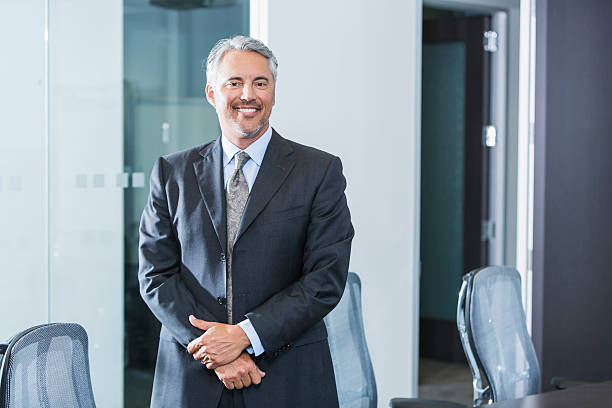 istock Businessman wearing gray suit standing in office 486884548