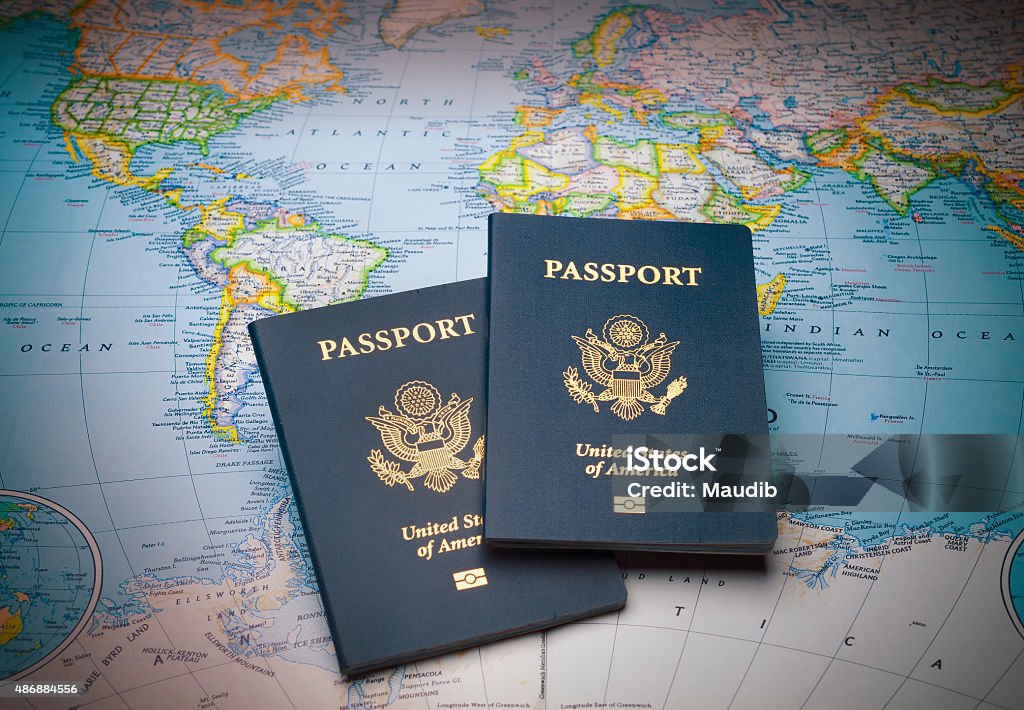 Passports on a map of the world Passports on a map of the world to illustrate the keys to world travel Passport Stock Photo