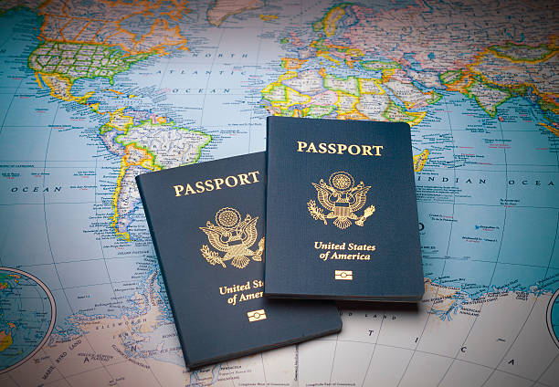 Passports on a map of the world Passports on a map of the world to illustrate the keys to world travel passport stock pictures, royalty-free photos & images