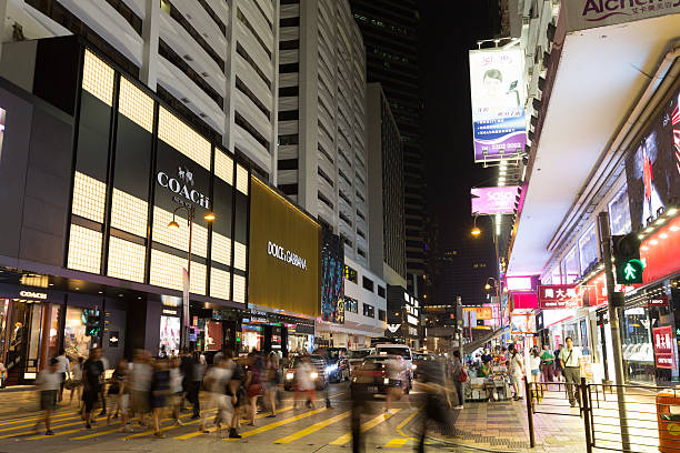 Hong Kong, Hong Kong SAR - September 11, 2015: People walk past Canton Road, Tsim Sha Tsui, Hong Kong. Luxury goods companies are expanding rapidly in Hong Kong. Canton Road is a luxury brands shopping street in Hong Kong. 