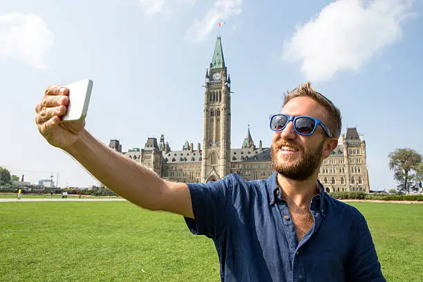 Photo of One tourist taking selfie portrait at Ottawa parliament