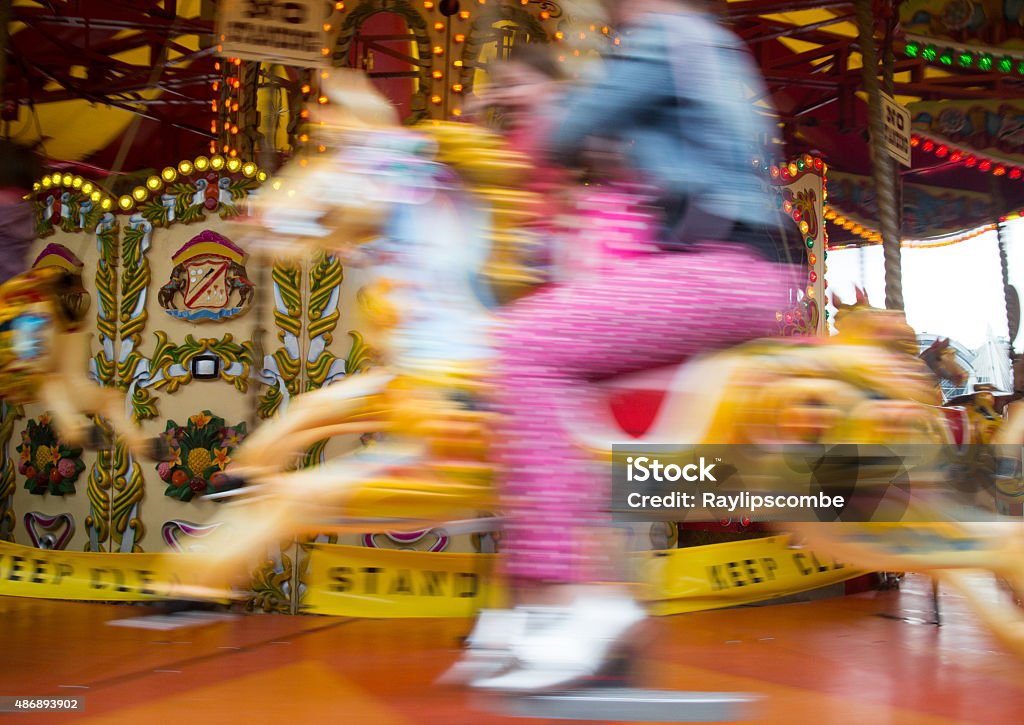 Riding a carousel at a fairground 2015 Stock Photo