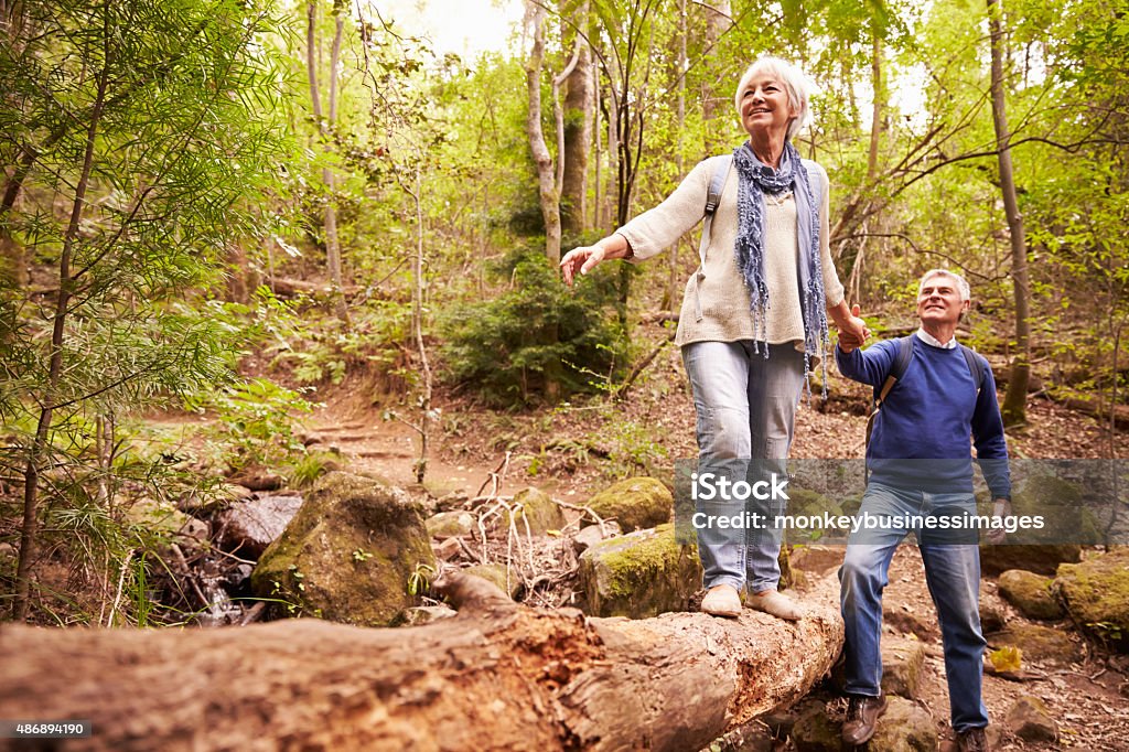 Senior couple walking together in a forest Balance Stock Photo