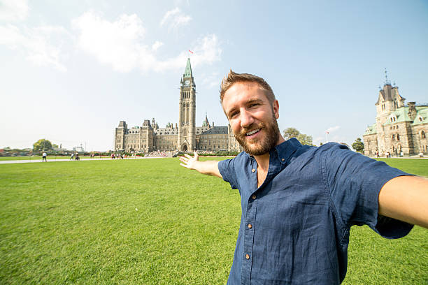 istock Cheerful man traveling takes selfie in Ottawa 486894894