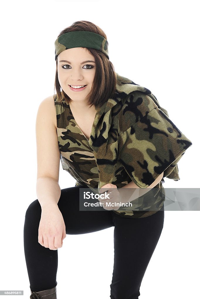 Pretty Camo Girl A beautiful teen girl leaning forward in her camouflage headband and shirts.  She's also slung a camo jacket over her shoulder.  On a white background. 16-17 Years Stock Photo