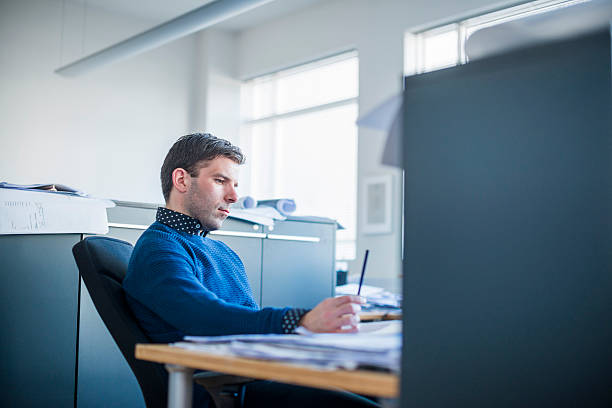 istock Concentrated businessman working in office 486897092