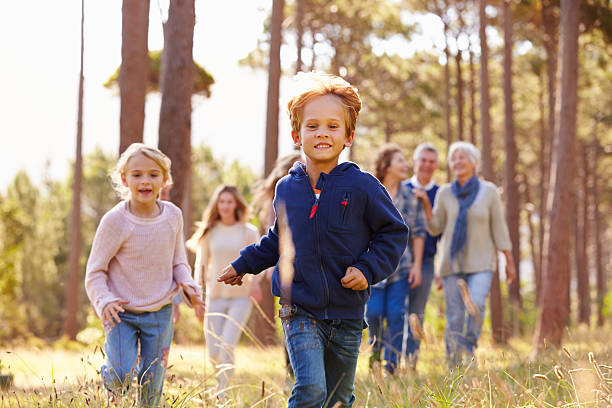 istock Multi-generation family walking in countryside, kids running 486897524