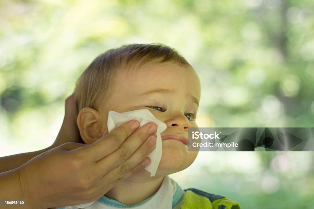 Mother cleans the baby Mother cleans the baby with wet wipes Baby - Human Age Stock Photo