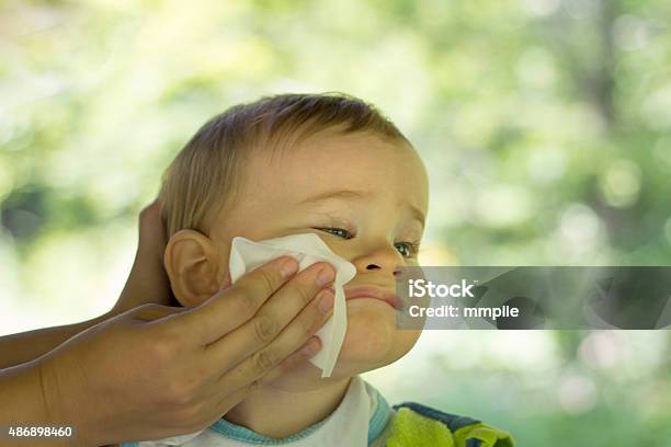 Mother Cleans The Baby Stock Photo - Download Image Now - Baby - Human Age, Vomit, Wet Wipe