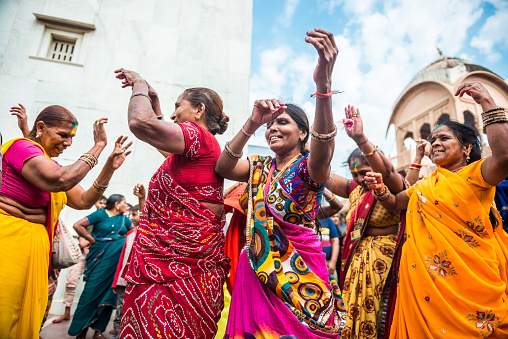 Barsana, India - March 10, 2014: Senior Indian women celebrate Holi dancing in Radha Rani Temple in Barsana Village.