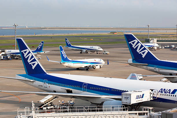 Tokyo, Japan - October 24, 2011: A chunk of All Nippon Airways passenger airplanes at Tokyo International Airport (Haneda Airport) Terminal 2 in Japan. All Nippon Airways is one of the largest airlines in Japan.