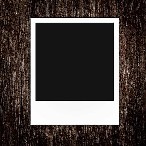 istock blank polaroid photo frame on brown wood plank background 486899043