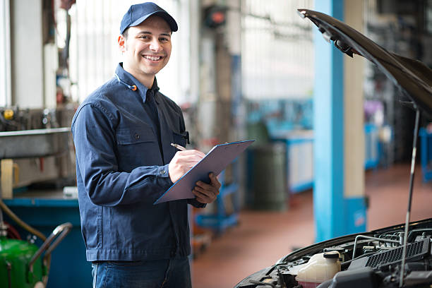 istock Smiling mechanic at work in his garage 486899784